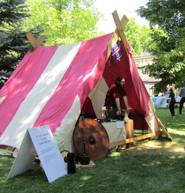 Tent at the Fire &amp; Ice Festival in Spanish Fork, Utah challenging festivalgoers to lift Thor's hammer.