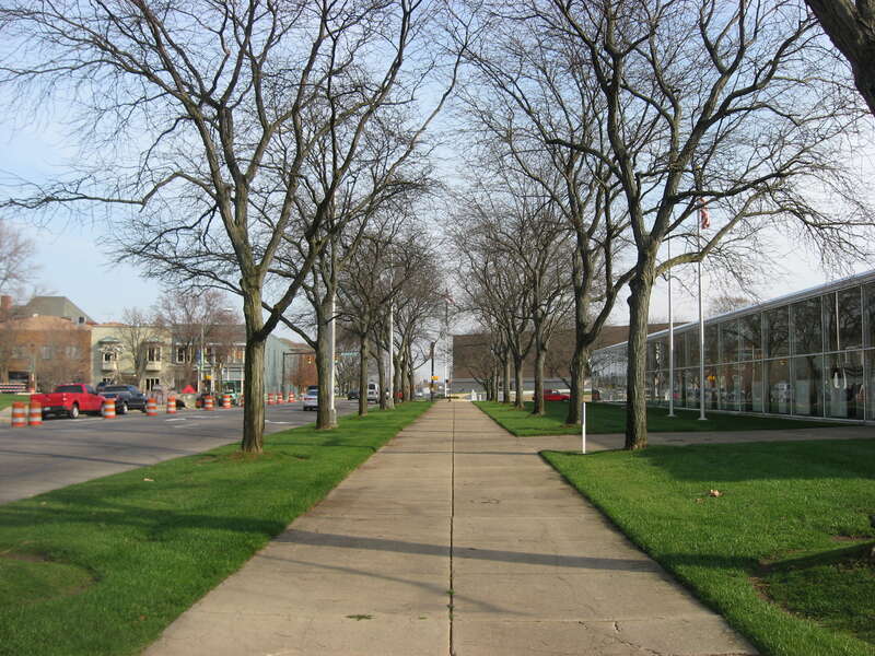 Looking eastward along the sidewalk in front of the offices of The Republic, located at 333 Second Street (State Road 46) in Columbus, Indiana, United States.  Built in 1971, it has been designated a National Historic Landmark, and the landscaping