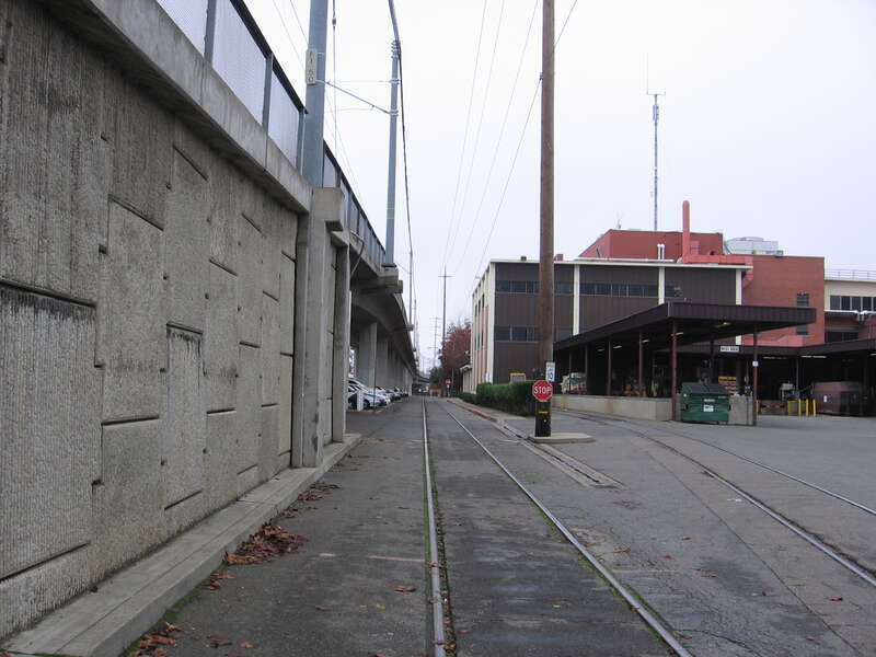 The main offices of The Sacramento Bee on the right, with the Sacramento RTD light rail Gold Line overpass on the left.  The overpass carries the Gold Line (Sacramento RT) over the Union Pacific Railroad line and several local streets and runs from