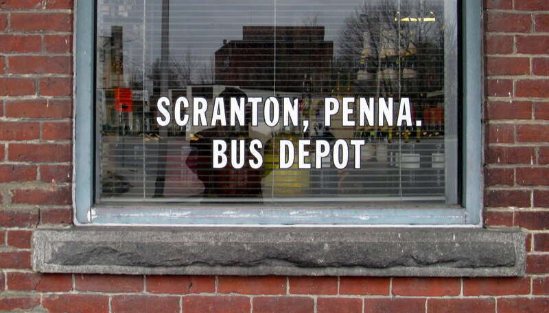 Decal reading "SCRANTON, PENNA. BUS DEPOT" on a window of the former Leominster station in December 2014. The building was used as a set for the 1992 movie School Ties.