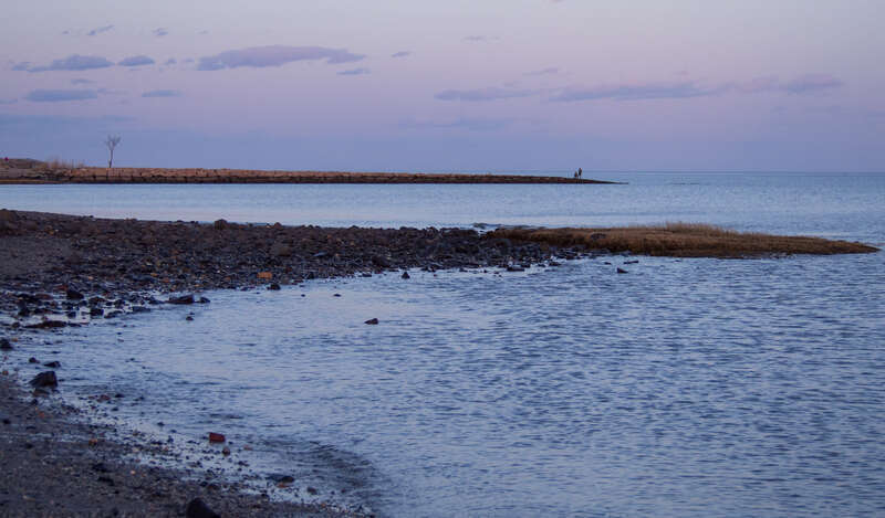 The beach of Silver Sands State Park near sunset.
