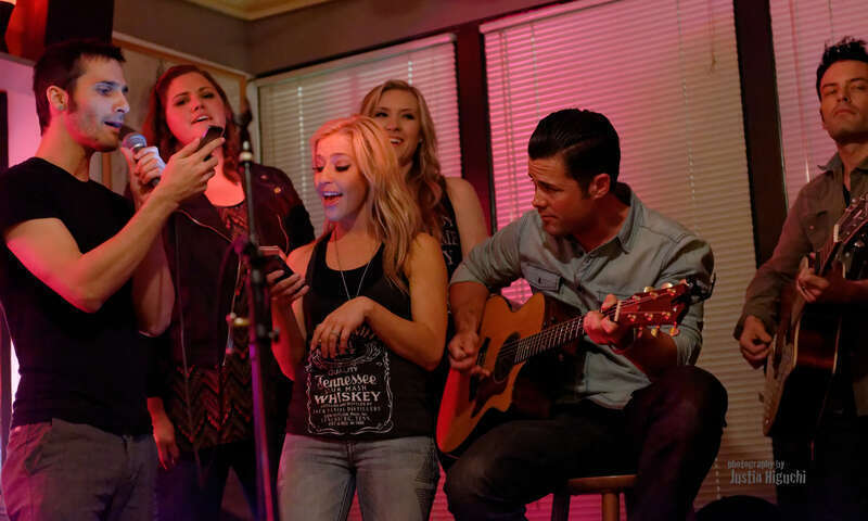 "NAMM Week: Songwriter Series" Songwriters Round at The Ugly Mug Cafe in Orange CA on January 22nd, 2014. Kaela Kinney (tall blonde), Ry Bradley (right), Ryan Terrigno (left), Katelyn Marie (Jack Daniels tshirt), Heidi Howard (dark hair), and Scott