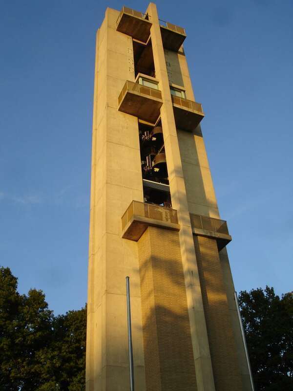The brutalist tower of the Thomas Rees Memorial Carillon. It is located in Washington Park in Springfield, Illinois. The bells of the carillon are clearly visible in this image.
