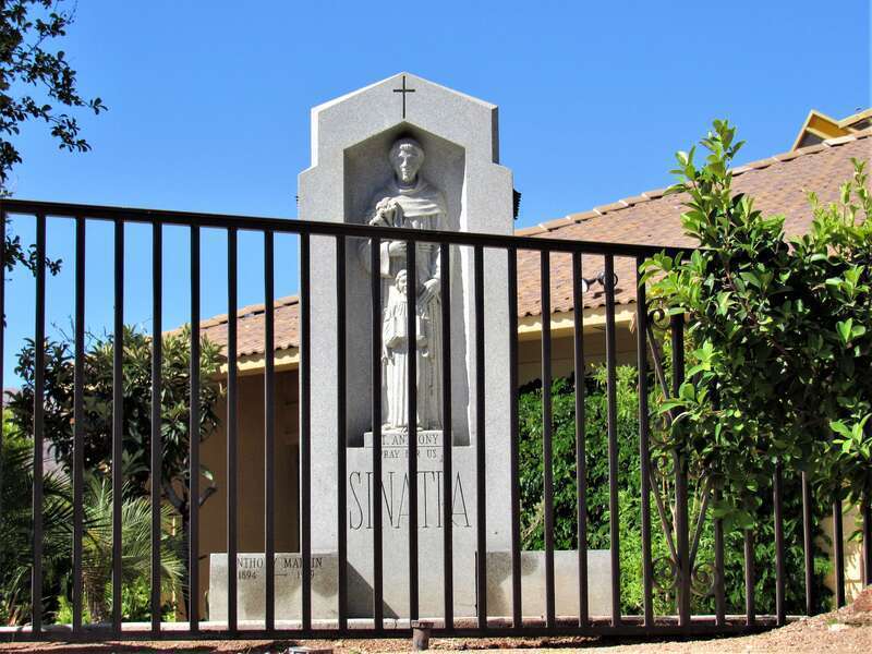 St Anthony of Padua shrine with "SINATRA" in large letters on the main shaft and "Anthony Martin 1894-1969" on the lower left. It is located behind St. Louis Catholic Church in Cathedral City, California.