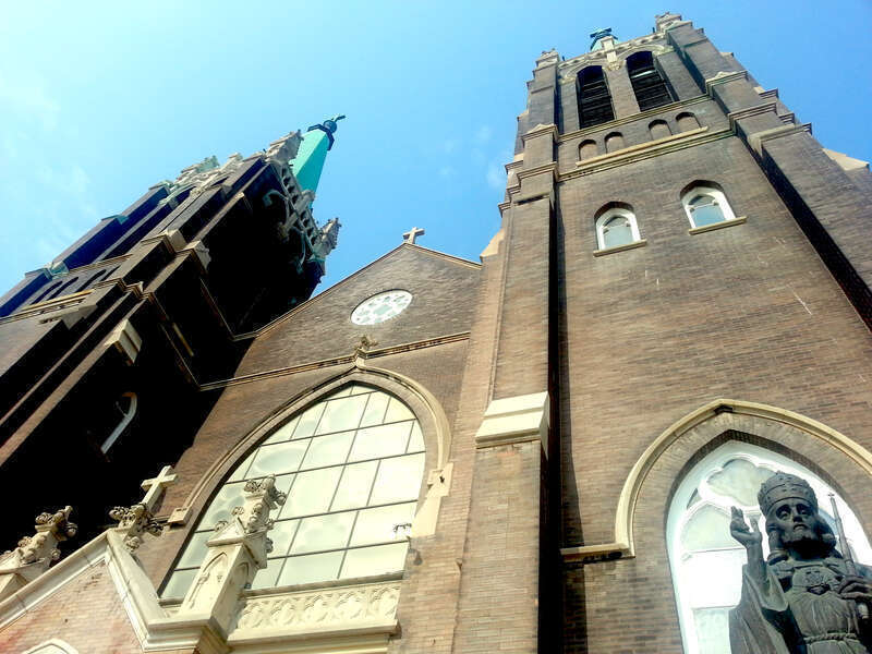 The front of St. Mary of Częstochowa Church in Cicero, Illinois and the head of the Christ Statue by Czesław Dźwiga