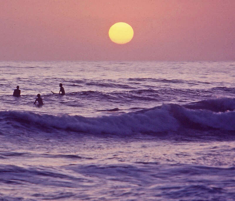 (1 in a multiple picture album)I was shooting pictures of the sunset from the balcony of our apartment when I spotted these surfers out a ways.  With my zoom I got a shot of them.  The sky and sea were amazing in color at that moment.