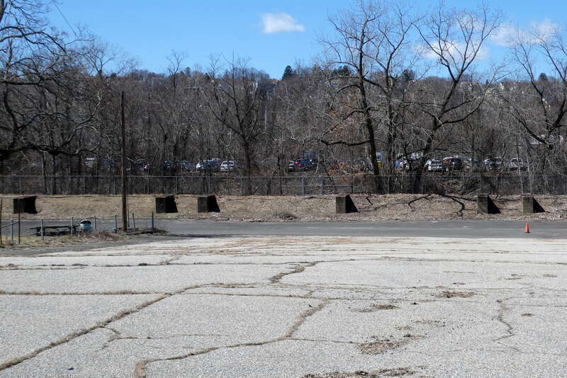 Supports of the former Meriden, Waterbury and Connecticut River Railroad trestle in Waterbury, seen in March 2023. The wooden trestle remained in use until the 1990s.
