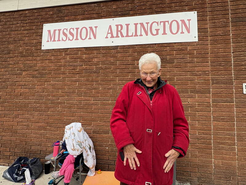 Tillie Burgin in front of the Mission Arlington sign, taken Thanksgiving day 2024
