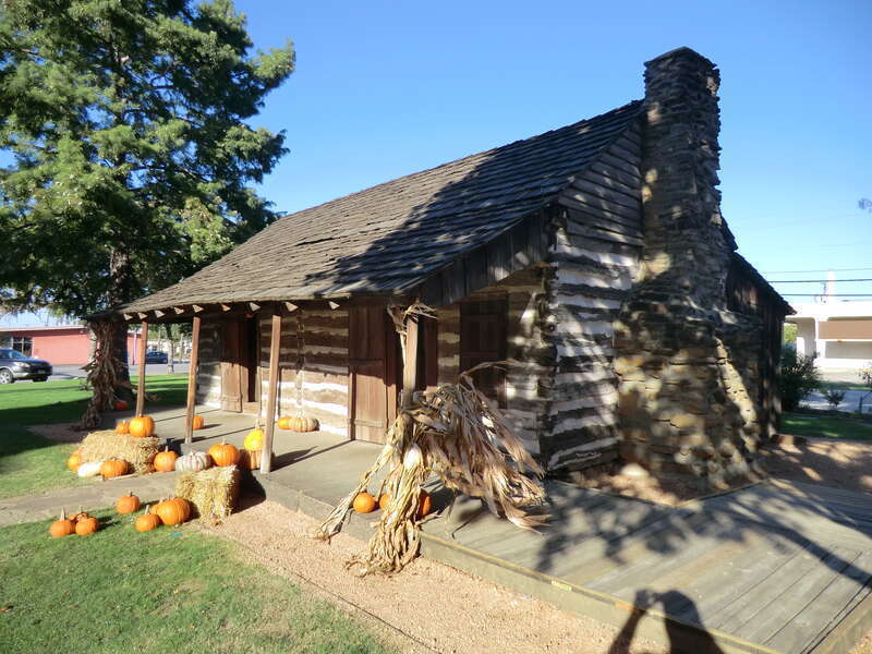 Photo of the old Torian Log Cabin, first built in 1845, now on Main Street, Grapevine, TX.