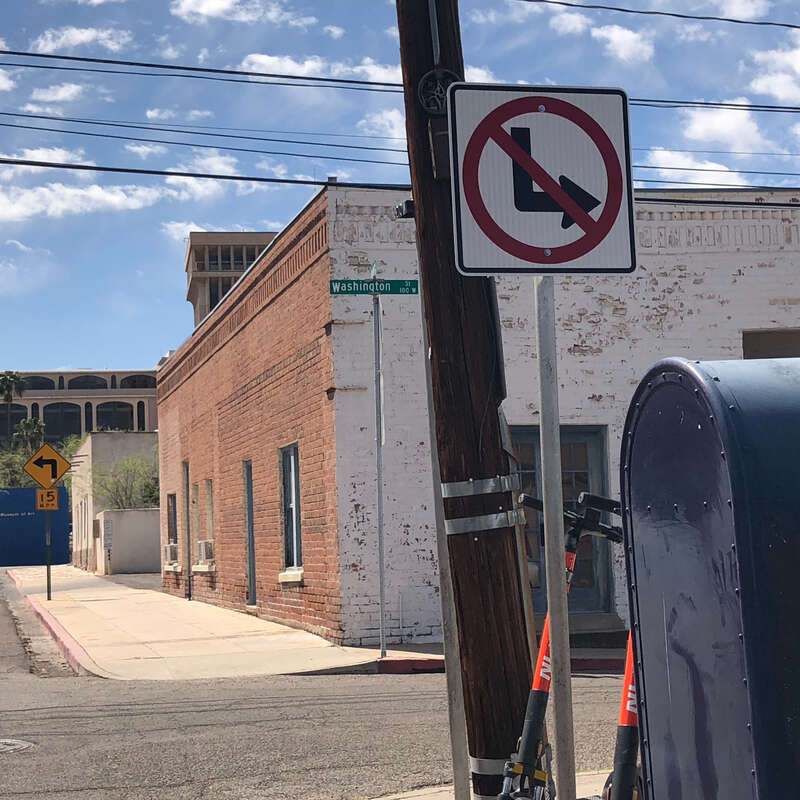An upside-down No Left Turn sign along southbound North Meyer Avenue in Tucson, Arizona, United States, appears to indicate that opposing (northbound) traffic may not turn left at West Washington Street. However, neither can southbound traffic turn