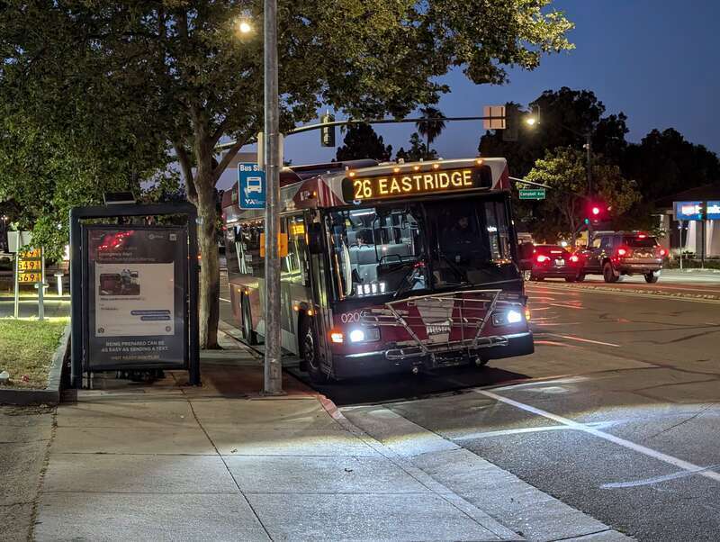 SCVTA bus number 0209, a Gillig Low Floor HEV, serving route 26 eastbound at Campbell Ave and Bascom Ave in Campbell, California at nighttime. The destination sign on the front reads "26 EASTRIDGE".