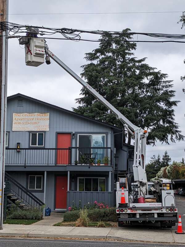 A cable worker performing a task in a cherry picker for the Xfinity company, in Campbell, California.