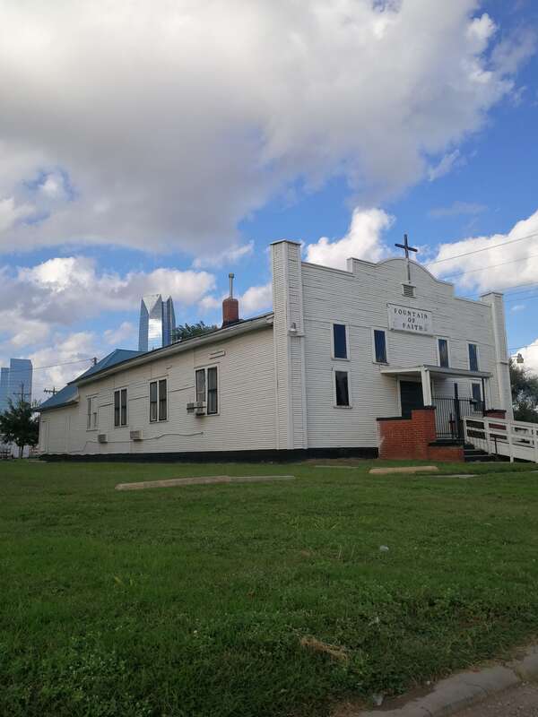 Hundred-year-old Czechoslovakia Community Center building in Oklahoma City, set to be restored as an item in the MAPS Park project. In the background is the new Devon Building.