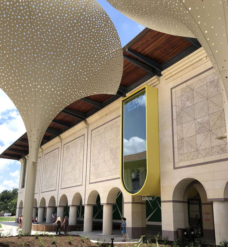 Exterior grounds and plaza designed by Snøhetta at the Blanton Museum of Art in Austin, Texas. Features include twelve towering, three-stories-tall "petals" which provide perforated shade. Other Snøhetta interventions include, above the main entrance