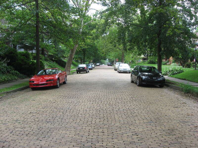 Northward along a neighborhood brick street in the borough of Swissvale, an eastside suburb of Pittsburgh, Pennsylvania, United States.  Taken northward along LaClair Avenue between Hutchinson Avenue and Sanders Street, this is a typical street for