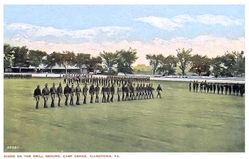 This colorized photo postcard shows USAAC trainees marching in formation in the infield area of the horse racing track at Camp Crane.    This area was used primarily as a drill and formation field, as well as for training classes by the Ambulance