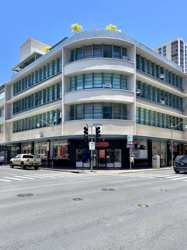 Built in 1955, this modernist building was designed by Ernie Hara for the Central Pacific Bank.  The concrete building features concrete canopies on each floor, ribbon windows on the second, third, and fourth floors, a rounded corner, a first floor