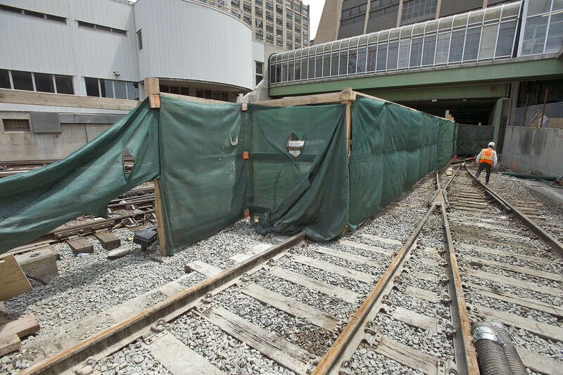 Giant cranes and boring machines work in tight quarters with the Long Island Rail Road’s 24/7 operations at the LIRR west side storage yard to construct the platform that will support the office towers, apartments and shopping center of a new