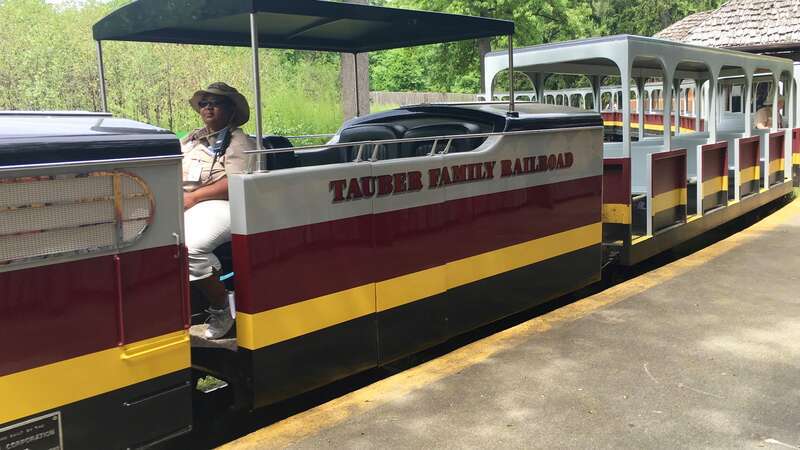 Signage on locomotive of Tauber Family Railroad pulling into the Africa Station at the Detroit Zoo.