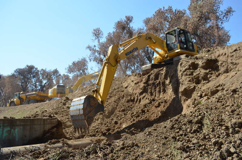 U.S. Army Corps of Engineers Sacramento District levee work is underway Aug. 21, 2013 along the north bank of the American River in north Sacramento, Calif. Complicating the work are land easement rights, an inactive railroad line and an assortment