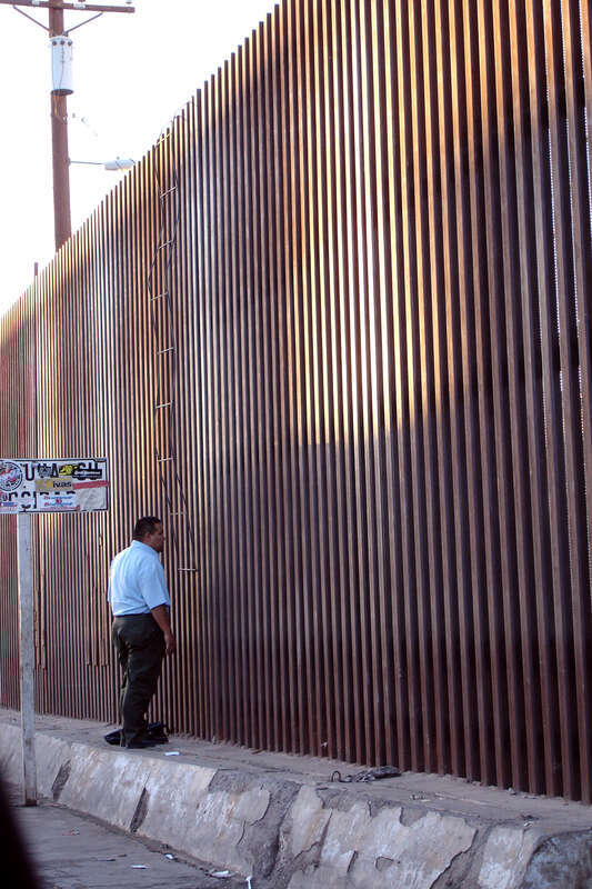 Lizbeth took this photo
A couple of guys showed up,
with a welded re-bar home-made ladder, to climb this umclimbable new fence. The home-made re-bar ladder was hooked up at the top of the fence simply by bending the re-bar and lifting the ladder