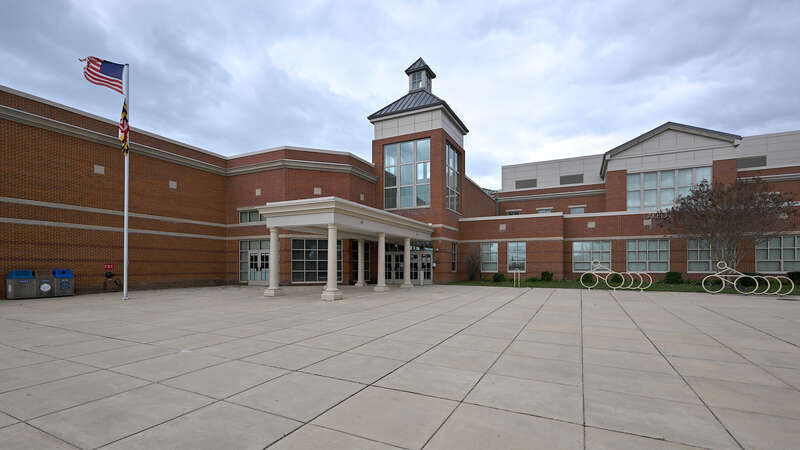 The front entrance to Lakelands Park Middle School, with a wide concrete area and canopy, part of the Montgomery County Public Schools system. 1200 Main Street, Gaithersburg, Maryland 20878.