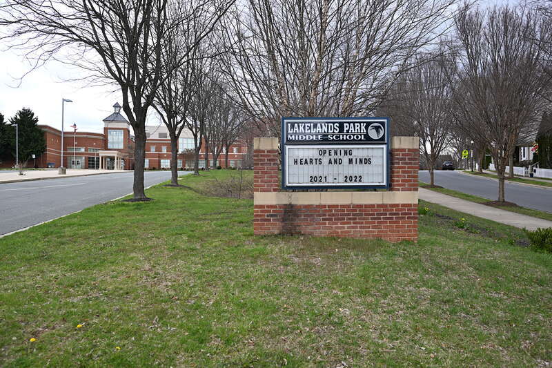 The sign for Lakelands Park Middle School with the building behind it, part of the Montgomery County Public Schools system. 1200 Main Street, Gaithersburg, Maryland 20878.