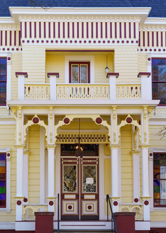 Front facade of the Lee-Mansfield House, a two-story wood structure in a Victorian Eclectic style at 344 Flume Street in the old eastern section of Chico. The property was bought in 1890 by Wesley C. Lee (1824–1896), founder of Lee's Pharmacy, dating