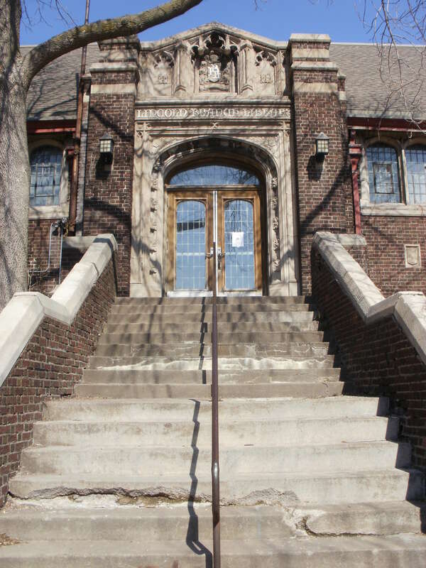 Detail of the entrance on the southeast face of the NRHP-listed Lincoln Branch Library in Duluth, Minnesota. Above the door is written "Lincoln Branch Library."