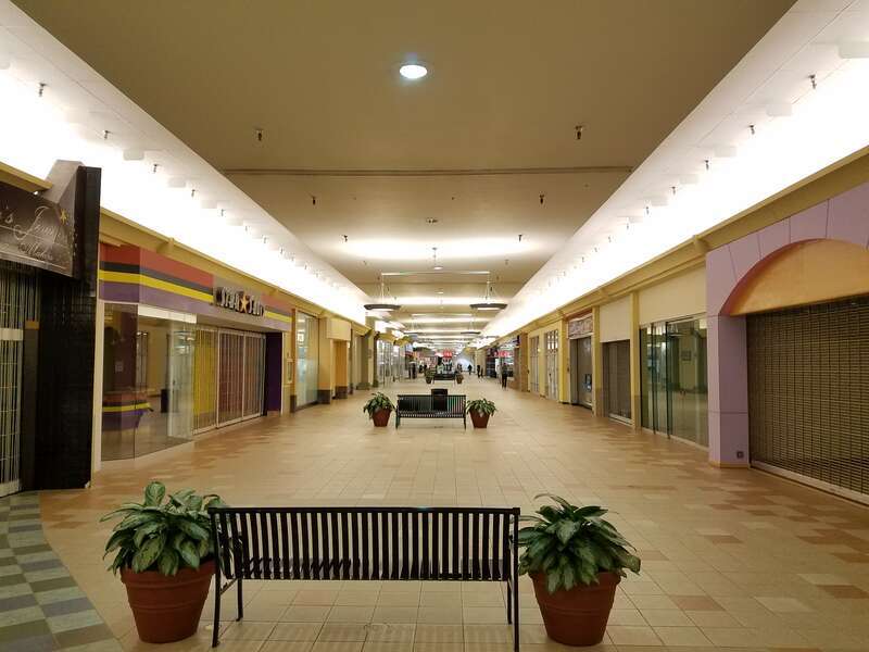 View of the main corridor inside Mall 205 in Portland, Oregon, USA in early 2018, with the numerous empty tenant spaces evident.