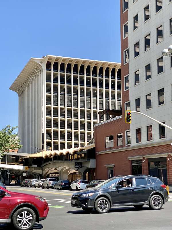 Built in 1967, this Brutalist building was designed by Warren C. Heylman to serve as a parking garage, known as Parkade Plaza.  The building features a concrete structure, exterior fins with flared brackets at the cornice, vaulted ceilings below the