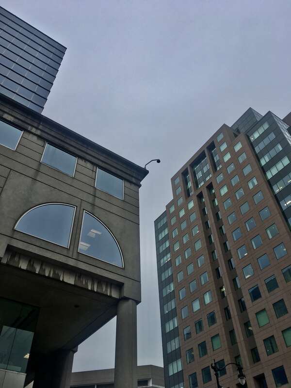 Towering paragons of postmodern architecture as seen from the corner of Main and East Chippewa Streets, Buffalo, New York, January 2020: the M&amp;T Center (left) and 50 Fountain Plaza (right).