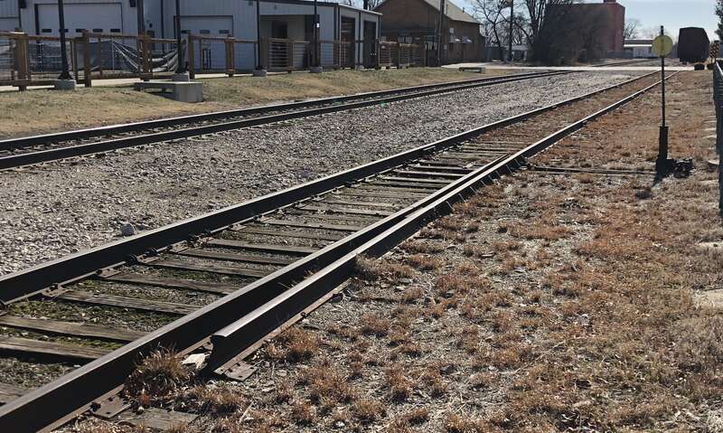 This derailed is a split-rail type, basically just a portion of a railroad "Switch". It's intended to direct cars off the rails to prevent them from entering an area they should not (in this case, a road crossing).