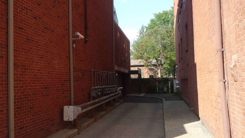 Fixed camera in alley next to Aces ECA facing Audubon St