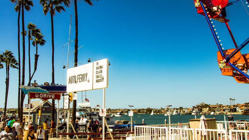 Clear warm spring day. Lots of people enjoying the weather in the Balboa Village.

Newport Beach, California