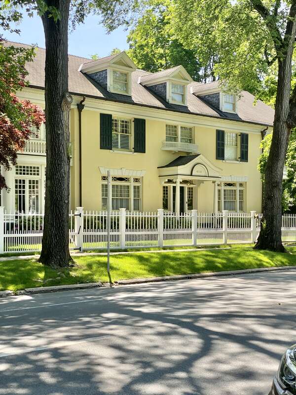 Built in 1880 and later renovated heavily in the early 20th Century, this Renaissance Revival-style house features a stucco-clad exterior, side gable roof, a cornice with dentils eighteen-over-one, twelve-over-one, eight-over-one, and six-over-one