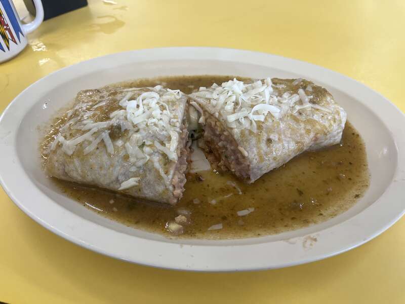 This is a Chile Rellenos Burrito from El Taco de Mexico which has been ordered "smothered", in which the burrito has green chili poured on top of it.