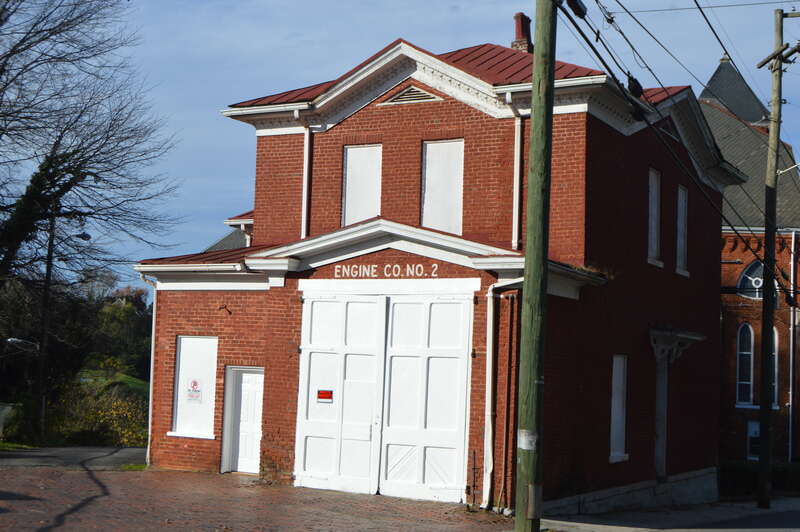 Front and eastern side of the Diamond Hill Fire Station, located on Grace Street at Pearl Street in Lynchburg, Virginia, United States.  (To the rear is Diamond Hill Baptist Church.)  Built in 1883, it is part of the Diamond Hill Historic District, a
