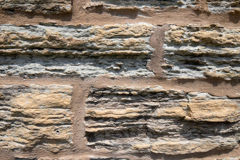 Limestone detail, Water tower, Ellwood House, DeKalb, Illinois. "On the west (rear) of the Ellwood House, the circular limestone water tower is about 50 feet (15.2 m) tall and has a diameter of 18 feet (5.5 m). The tower has windows occurring at