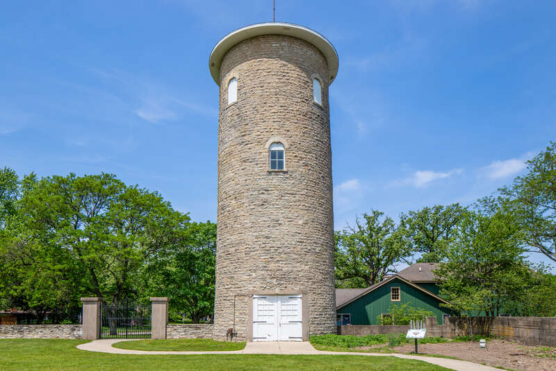 Water tower, Ellwood House, DeKalb, Illinois. "On the west (rear) of the Ellwood House, the circular limestone water tower is about 50 feet (15.2 m) tall and has a diameter of 18 feet (5.5 m). The tower has windows occurring at different levels,