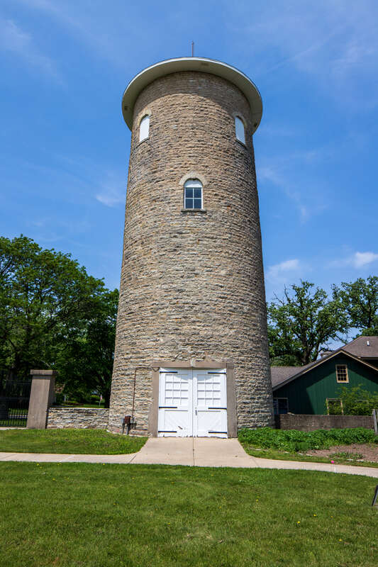 Water tower, Ellwood House, DeKalb, Illinois. "On the west (rear) of the Ellwood House, the circular limestone water tower is about 50 feet (15.2 m) tall and has a diameter of 18 feet (5.5 m). The tower has windows occurring at different levels,