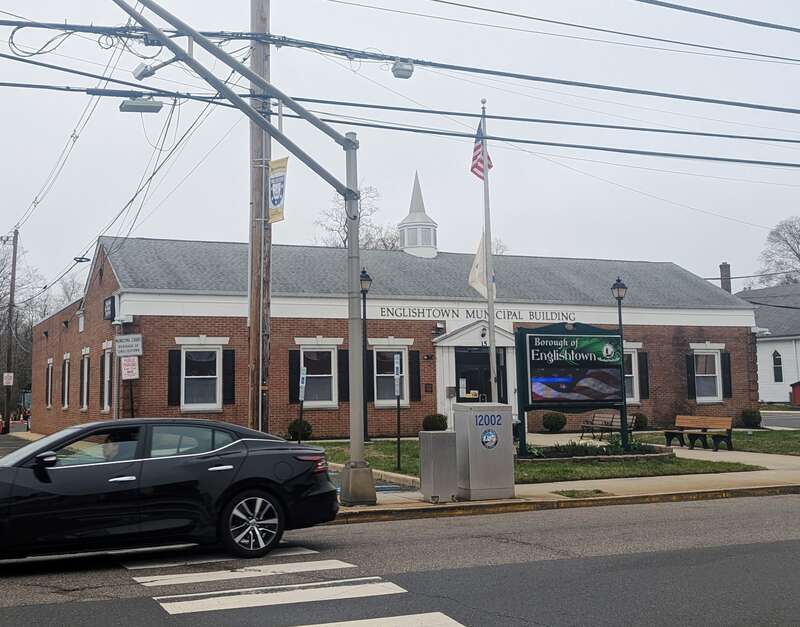 Photo of the Englishtown, New Jersey Municipal Building. Photo taken from County Route 522 (Tennent Avenue) looking west-northwest across CR 527 (Main Street).