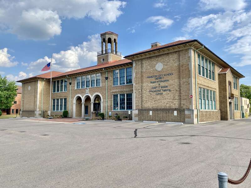 Built in 1909 as the Hamilton Catholic School, this Renaissance Revival-style building served as a catholic school until it was replaced with a more modern building in 1966.  The building features a buff brick exterior with a hipped roof, bracketed