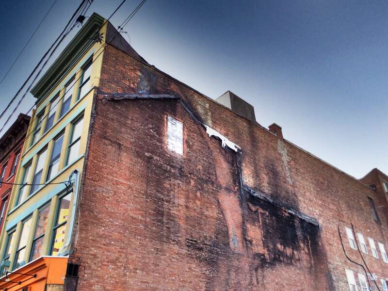 Charred image of the building that used to stand next to this one, in Jersey City, New Jersey.