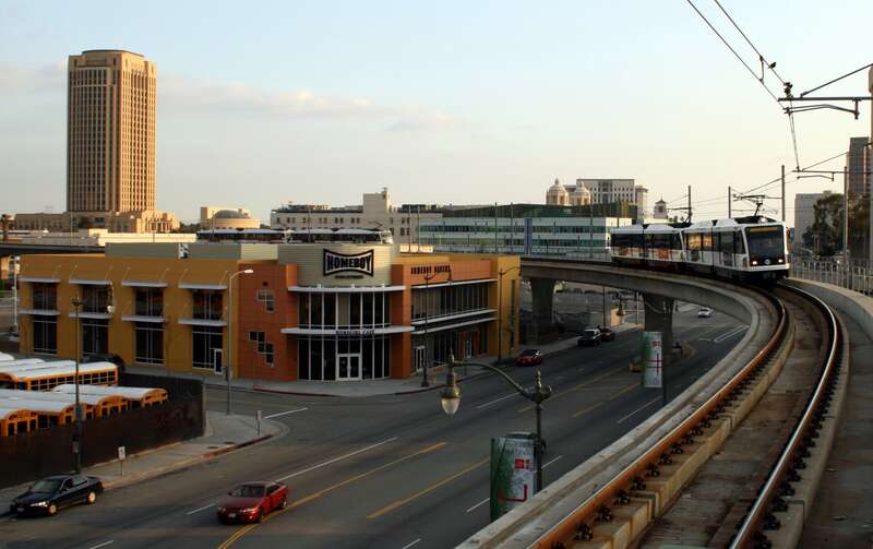 Metro Gold Line train approaching Chinatown Station, just north of downtown Los Angeles, California. The MTA headquarters is the tall building to the left. Photo is taken from the platform of Chinatown Station, looking south/southeast.
