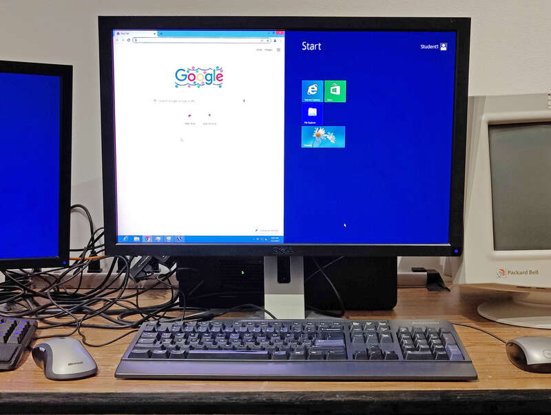 Microsoft Windows Multipoint Server 2012 displaying two concurrent desktop sessions (controlled by two separate sets of keyboards and mice) on one monitor, using the "split station" feature