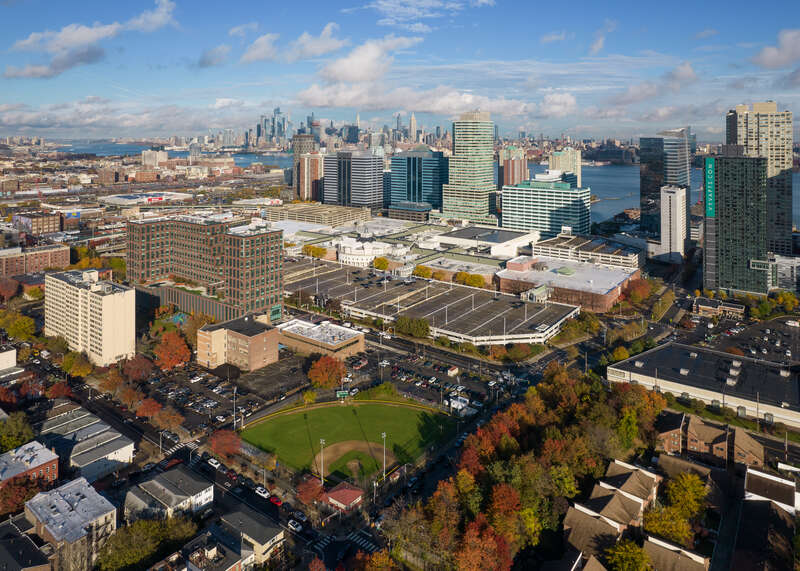 Newport, Jersey City, New Jersey, with parts of Hamilton Park in the foreground.