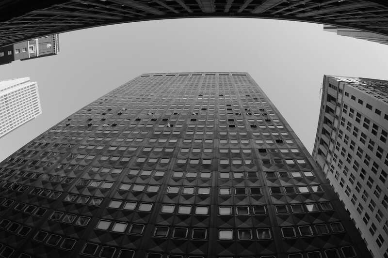 Downtown Pittsburgh PA.  Faced with aluminum panels and designed with windows that rotate outward.  Fisheye perspective, B&amp;W image.