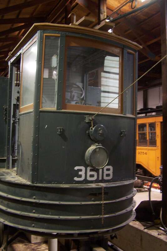 A work car under repair in the shop at the PA Trolley Museum in Washington, PA.  This car will assist in reballasting the "right of way" at the museum.