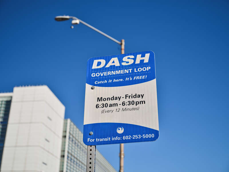 A sign for the Valley Metro DASH Government Loop bus in downtown Phoenix, Arizona. "Catch it here. It's free! Monday - Friday 6:30am - 6:30 pm (Every 12 minutes) For transit info: 602-253-5000"